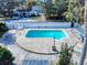 Inviting in-ground pool surrounded by a spacious deck, enclosed by a privacy fence and lush greenery at 634 N Riverside Dr, New Smyrna Beach, FL 32168