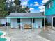 Charming pool house with a white trim, wood bench, and easy pool access at 634 N Riverside Dr, New Smyrna Beach, FL 32168