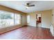 Sunny room with tile flooring, a ceiling fan, and views of the backyard and landscaping at 634 N Riverside Dr, New Smyrna Beach, FL 32168