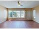 Inviting sunroom featuring tile flooring, a ceiling fan, and large windows with backyard views at 634 N Riverside Dr, New Smyrna Beach, FL 32168