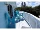 Balcony with blue chairs and small table, offering an outdoor seating area at 6345 River Rd, New Smyrna Beach, FL 32169