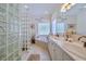 Elegant bathroom with double vanity, glass block shower, and soaking tub at 6345 River Rd, New Smyrna Beach, FL 32169