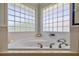 Relaxing corner bathtub with glass block windows in bathroom at 6345 River Rd, New Smyrna Beach, FL 32169