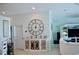 Entryway with large clock and white cabinet with glass doors at 6345 River Rd, New Smyrna Beach, FL 32169