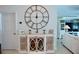 Entryway with large clock and white cabinet with glass doors at 6345 River Rd, New Smyrna Beach, FL 32169