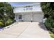 Two-story home with light blue exterior, white balcony, and double garage at 6345 River Rd, New Smyrna Beach, FL 32169