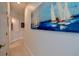 Bright hallway with artwork and access to other rooms at 6345 River Rd, New Smyrna Beach, FL 32169