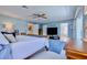 Bright main bedroom with king bed and ensuite bathroom at 6345 River Rd, New Smyrna Beach, FL 32169