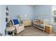 Charming Bedroom with light blue walls, a crib, and ample storage at 6807 Ragatz Ln, Port Orange, FL 32128