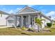 Gray craftsman style home with rocking chairs on the front porch at 6807 Ragatz Ln, Port Orange, FL 32128