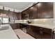 Well-equipped kitchen featuring dark cabinets and ample counter space at 6807 Ragatz Ln, Port Orange, FL 32128