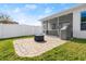 Screened patio with brick pavers and fire pit at 6807 Ragatz Ln, Port Orange, FL 32128