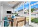 Screened porch with wicker furniture and a TV at 6807 Ragatz Ln, Port Orange, FL 32128