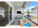 Relaxing screened porch with comfy seating and TV at 6807 Ragatz Ln, Port Orange, FL 32128