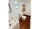 Charming half bathroom with floating shelves at 69 E Bayshore Dr, Port Orange, FL 32127