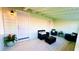Relaxing screened porch with wicker furniture, creating an outdoor oasis at 69 E Bayshore Dr, Port Orange, FL 32127