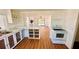 Bright kitchen featuring white cabinets, a peninsula, and modern appliances at 69 E Bayshore Dr, Port Orange, FL 32127