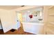 Open concept living area with kitchen and wood-look floors at 69 E Bayshore Dr, Port Orange, FL 32127