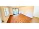Living area with wood-look floors and access to a screened porch at 69 E Bayshore Dr, Port Orange, FL 32127