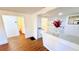 Living room with wood-look floors and views into the kitchen and bathroom at 69 E Bayshore Dr, Port Orange, FL 32127