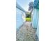 Side yard view showing home exterior and access to backyard at 69 E Bayshore Dr, Port Orange, FL 32127