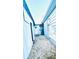 Home side yard with gravel pathway, storage shed, and exterior access at 69 E Bayshore Dr, Port Orange, FL 32127