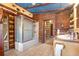 Rustic bathroom with log cabin walls, shower, and tile floors at 735 S Glencoe Rd, New Smyrna Beach, FL 32168