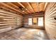 Simple bedroom with hardwood floors and log cabin walls at 735 S Glencoe Rd, New Smyrna Beach, FL 32168