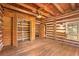 Charming log cabin bedroom with built-in closet and hardwood floors at 735 S Glencoe Rd, New Smyrna Beach, FL 32168