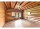 Simple log cabin bedroom with hardwood floors and a window at 735 S Glencoe Rd, New Smyrna Beach, FL 32168