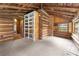 Log cabin bonus room with built-in shelving and window at 735 S Glencoe Rd, New Smyrna Beach, FL 32168