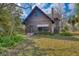 Rustic log cabin with charming landscaping at 735 S Glencoe Rd, New Smyrna Beach, FL 32168