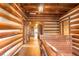 Rustic hallway with log cabin walls and wooden railing at 735 S Glencoe Rd, New Smyrna Beach, FL 32168