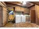 Rustic laundry room with washer, dryer, and wood cabinets at 735 S Glencoe Rd, New Smyrna Beach, FL 32168