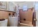 Vintage bathroom featuring a white vanity, peach-tiled walls, and a matching bathtub with shower at 8 Ocean Dr, Ormond Beach, FL 32176