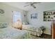 This spare bedroom features twin beds, coastal décor and a ceiling fan at 8 Ocean Dr, Ormond Beach, FL 32176