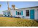 Quaint beach home featuring turquoise shutters and a well-maintained lawn at 8 Ocean Dr, Ormond Beach, FL 32176