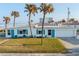 Charming beach house with turquoise shutters, palm trees, and an ocean view at 8 Ocean Dr, Ormond Beach, FL 32176