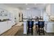 Bright kitchen featuring gray floors, white cabinets, and eat in bar seating at 8 Ocean Dr, Ormond Beach, FL 32176