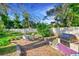 Brick patio with seating area, grill, and lush landscaping at 806 E 21St Ave, New Smyrna Beach, FL 32169