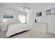 Bright bedroom with white furniture and ceiling fan at 806 E 21St Ave, New Smyrna Beach, FL 32169