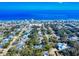 Expansive aerial view of a charming coastal community with a beautiful ocean backdrop on a sunny day at 808 E 19Th Ave, New Smyrna Beach, FL 32169