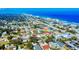 Picturesque aerial view of a coastal town with oceanfront homes and sandy beaches along a clear blue sea at 808 E 19Th Ave, New Smyrna Beach, FL 32169