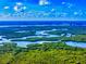 Scenic aerial view of lush mangrove islands and waterways under a partly cloudy sky, showcasing Florida's natural beauty at 808 E 19Th Ave, New Smyrna Beach, FL 32169