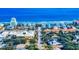 Aerial view of a coastal neighborhood with colorful houses and a clear view of the beach on a sunny day at 808 E 19Th Ave, New Smyrna Beach, FL 32169