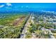 Wide aerial view of a neighborhood bordered by marshland and the beach, showing the area's location near nature at 808 E 19Th Ave, New Smyrna Beach, FL 32169