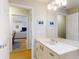 Bright bathroom vanity with a large mirror, with the living room visible through the doorway at 808 E 19Th Ave, New Smyrna Beach, FL 32169