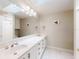 Bathroom featuring a vanity, large mirror, dual sinks and a skylight at 808 E 19Th Ave, New Smyrna Beach, FL 32169