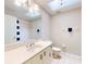 Well-lit bathroom featuring vanity, large mirror, and a tiled floor and walls at 808 E 19Th Ave, New Smyrna Beach, FL 32169