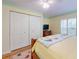 Bright bedroom with a white closet, a wooden bed frame, and warm yellow paint at 808 E 19Th Ave, New Smyrna Beach, FL 32169